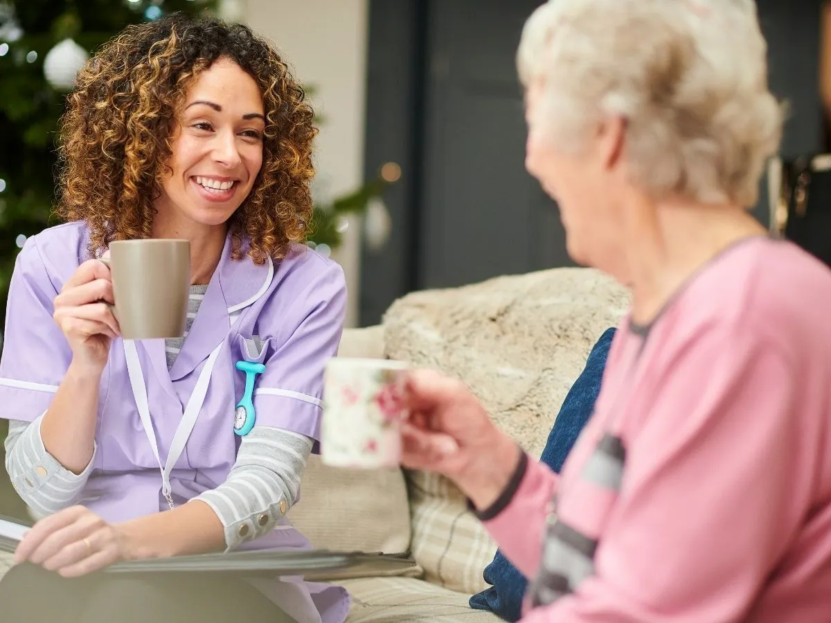 Caregiver and client sharing tea